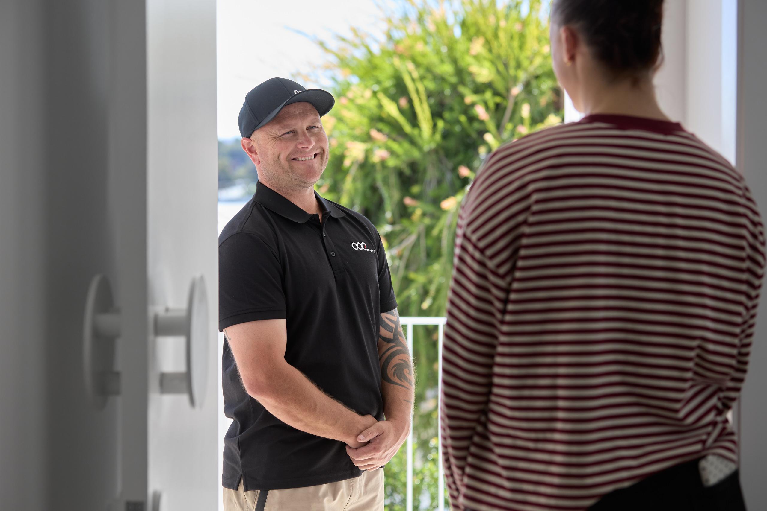 Resident greeting tradie at door